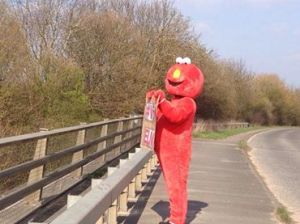 Elmo Protesting on Bridge